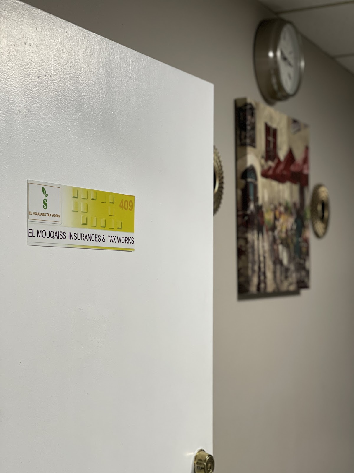 Mohamed at the El Mouqaiss Tax Office helping clients with professional tax preparation services